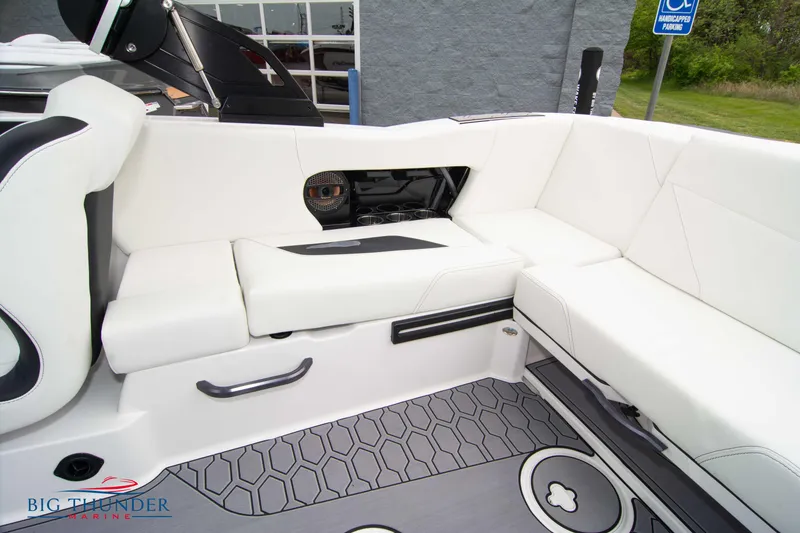 Slide: The Image of 2023 MasterCraft NXT22 boat interior with white seating and hexagonal floor pattern. - 16