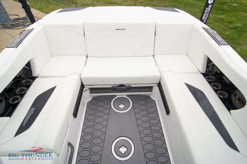 Slide: The Image of 2023 MasterCraft NXT22 boat interior with white seating and hexagonal floor design. - 18