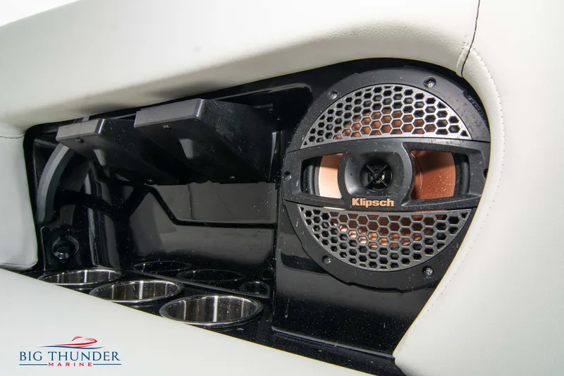 Slide: The Image of 2023 MasterCraft NXT22 boat interior with Klipsch speaker and cup holders. - 22