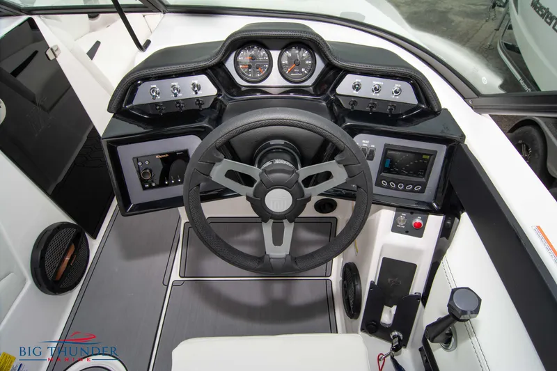 Slide: The Image of 2023 MasterCraft NXT22 boat dashboard with steering wheel and control panel. - 25