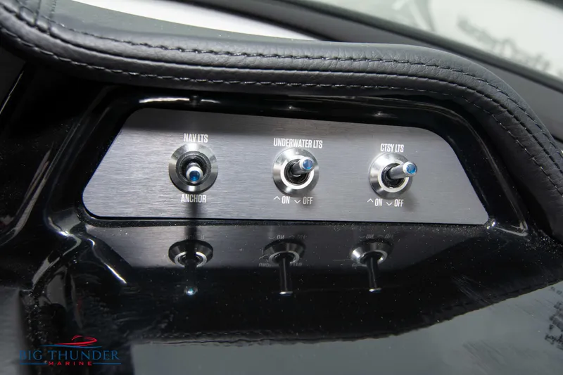 Slide: The Image of 2023 MasterCraft NXT22 control panel with switches for NAV/ITS, underwater lights, and courtesy lights. - 30
