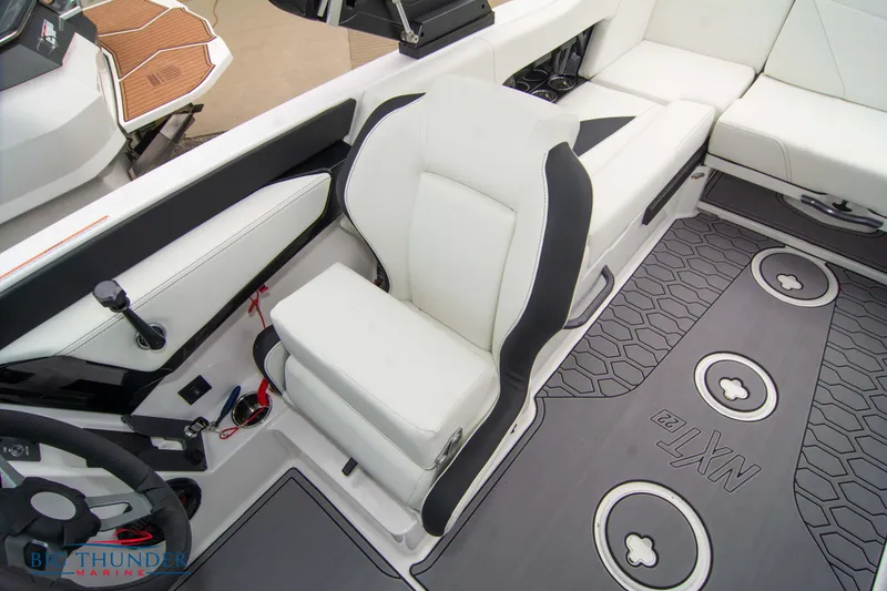 Slide: The Image of 2023 MasterCraft NXT22 boat interior with white and black seating and custom flooring. - 37