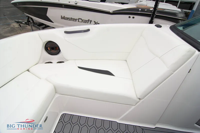 Slide: The Image of 2023 MasterCraft NXT22 boat interior with white seating and Big Thunder Marine logo. - 42