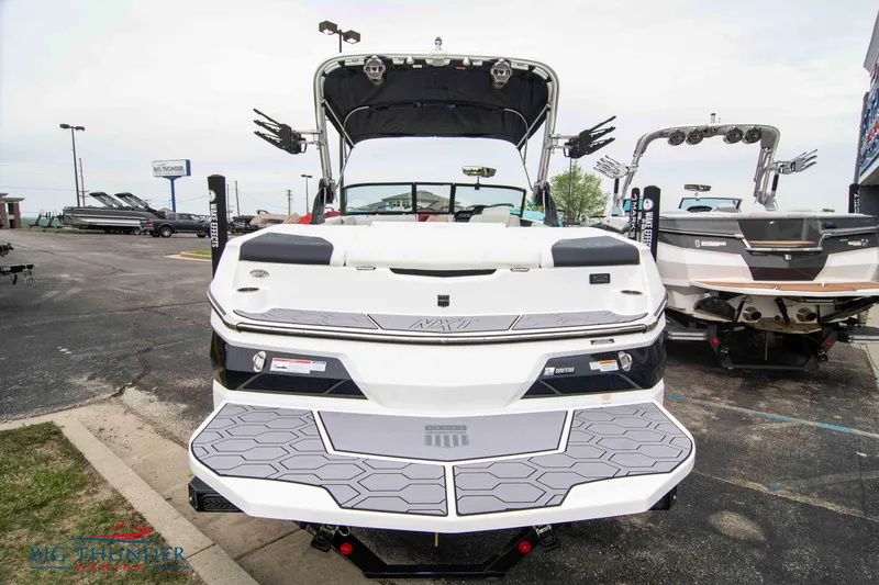 Slide: The Image of 2023 MasterCraft NXT22 boat displayed at a dealership. - 6