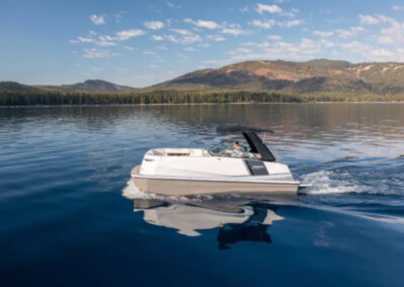 Slide: The Image of Ingenity EL 2025 electric boat cruising on a serene lake with mountain backdrop. - 0