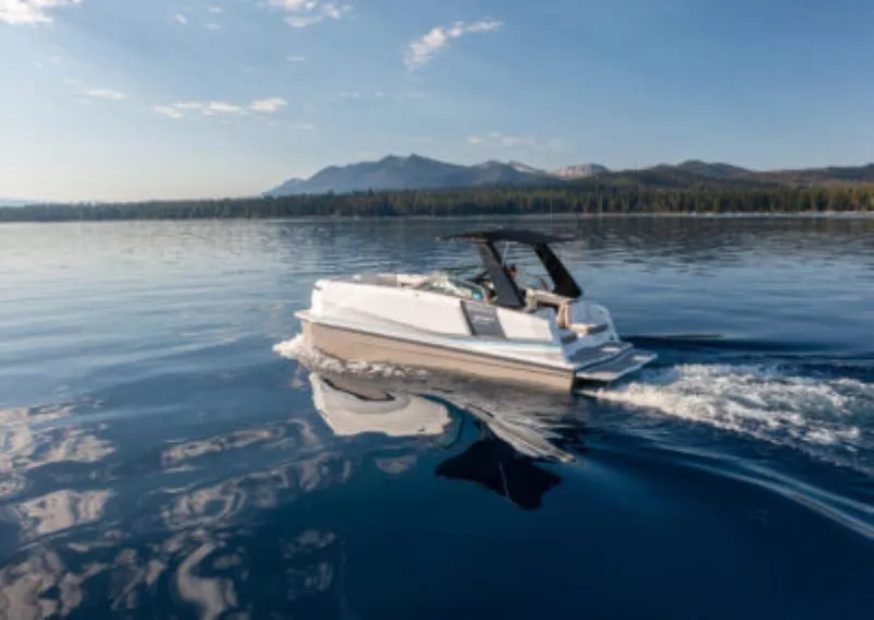 Slide: The Image of Ingenity EL 2025 electric boat cruising on a serene lake with mountain backdrop. - 1
