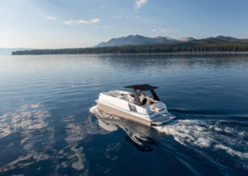 Slide: The Image of Ingenity EL 2025 electric boat cruising on a serene lake with mountain backdrop. - 2