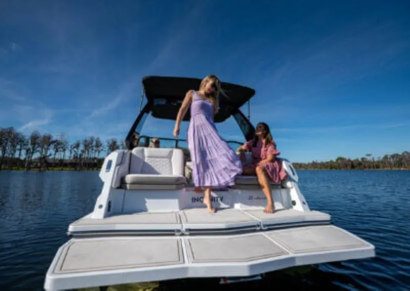 Slide: The Image of Women enjoying a day on a 2025 Ingenity EL boat on a sunny lake. - 4