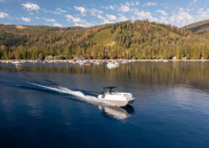 Slide: The Image of Ingenity EL 2025 boat cruising on a serene lake with forested hills in the background. - 7