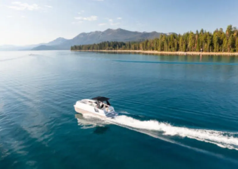 Slide: The Image of Ingenity EL 2025 boat cruising on a serene lake with forested shoreline. - 8