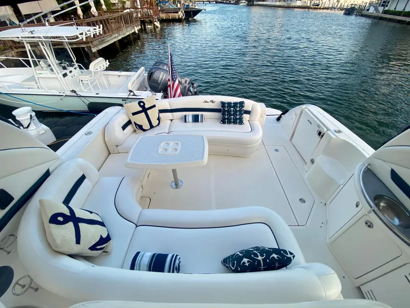 Slide: The Image of 2005 Sea Ray 420 Sundancer yacht with spacious deck and nautical-themed cushions. - 10