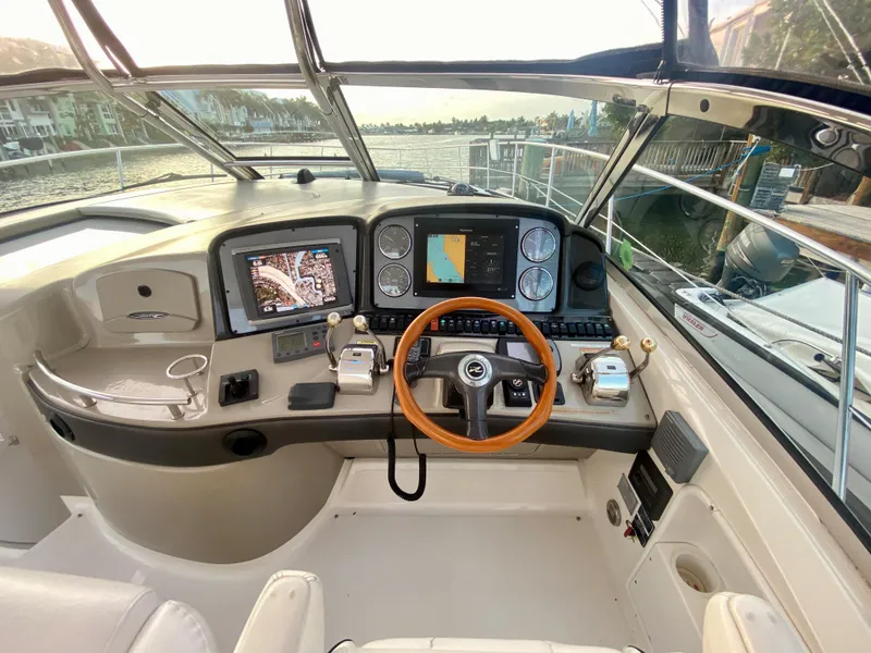 Slide: The Image of Helm of 2005 Sea Ray 420 Sundancer with navigation screens and wooden steering wheel. - 13