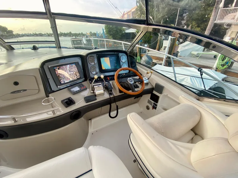Slide: The Image of Helm of 2005 Sea Ray 420 Sundancer with navigation screens and leather seats. - 14