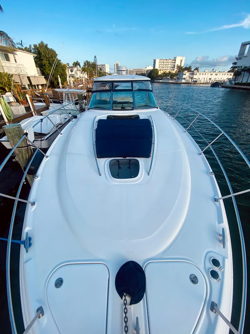 Slide: The Image of 2005 Sea Ray 420 Sundancer yacht docked in a scenic marina. - 19