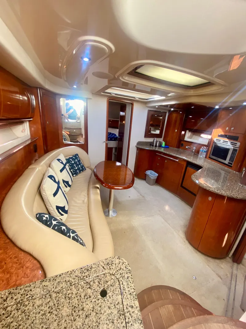 Slide: The Image of Interior of 2005 Sea Ray 420 Sundancer yacht with modern kitchen and cozy seating area. - 36