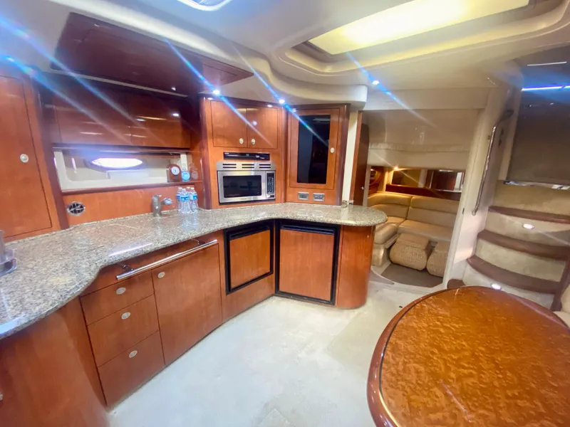 Slide: The Image of 2005 Sea Ray 420 Sundancer yacht interior with modern kitchen and cozy seating area. - 39