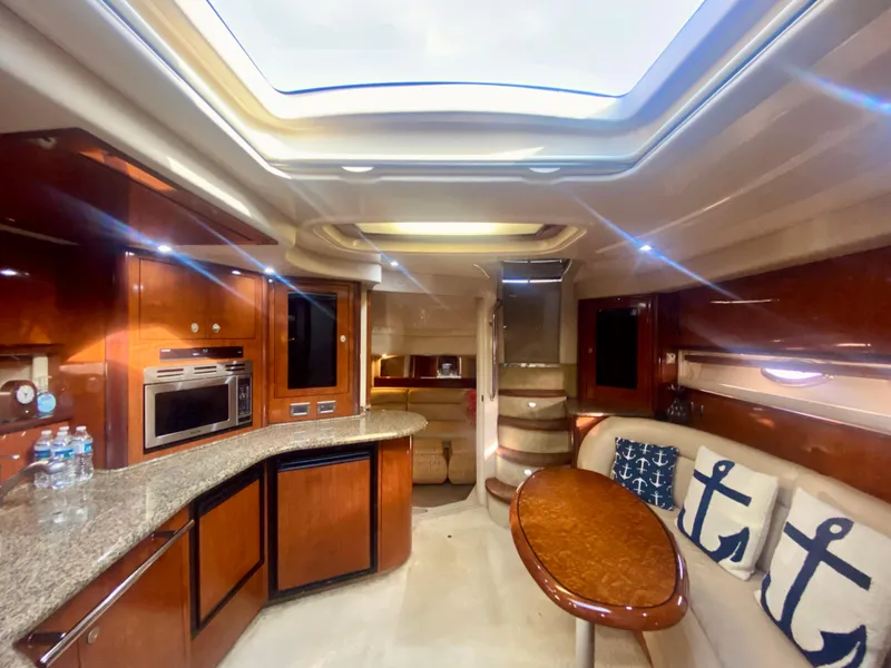 Slide: The Image of Luxurious interior of 2005 Sea Ray 420 Sundancer yacht with skylight, kitchen, and seating area. - 41