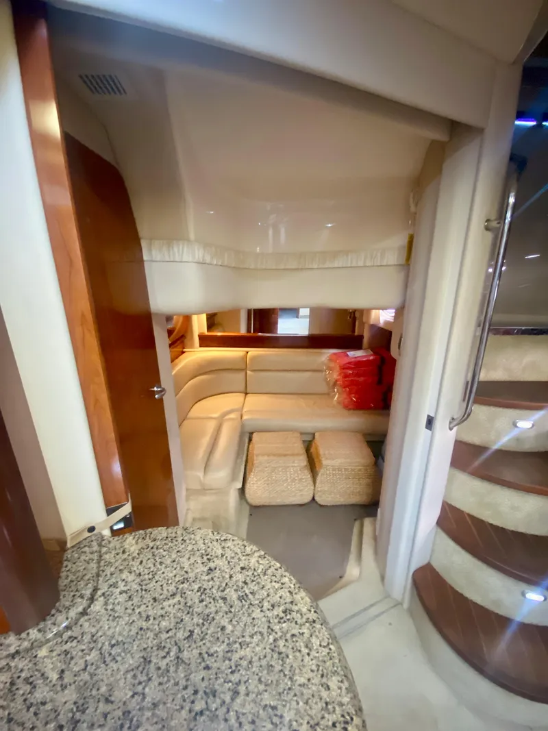 Slide: The Image of Interior cabin of 2005 Sea Ray 420 Sundancer with beige seating and wooden accents. - 44