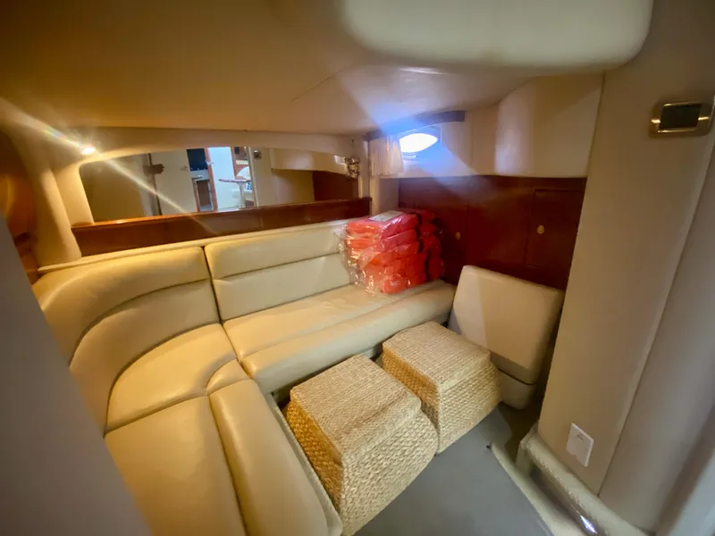 Slide: The Image of 2005 Sea Ray 420 Sundancer interior with beige leather seating and woven ottomans. - 45