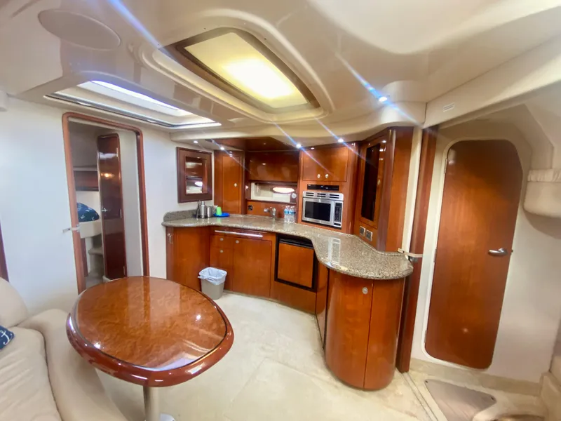 Slide: The Image of Luxurious interior of 2005 Sea Ray 420 Sundancer yacht with modern kitchen and dining area. - 46