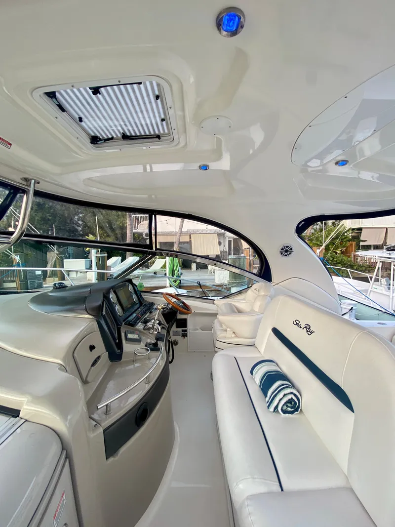 Slide: The Image of 2005 Sea Ray 420 Sundancer interior with helm and seating area. - 8