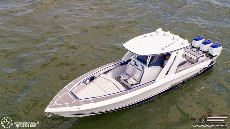 Slide: The Image of 2018 Statement 38 Open boat cruising on water with triple outboard engines. - 17