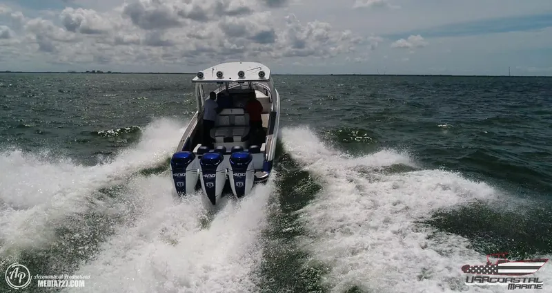 Slide: The Image of 2018 Statement 38 Open boat speeding on open water, triple engines, creating wake. - 28