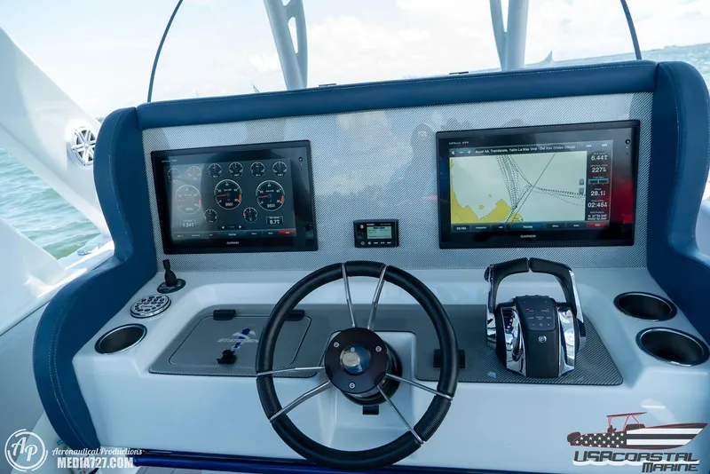 Slide: The Image of 2018 Statement 38 Open boat dashboard with dual screens and steering wheel. - 3