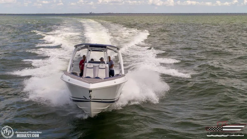 Slide: The Image of 2018 Statement 38 Open boat cruising on open water, creating a dynamic wake. - 31