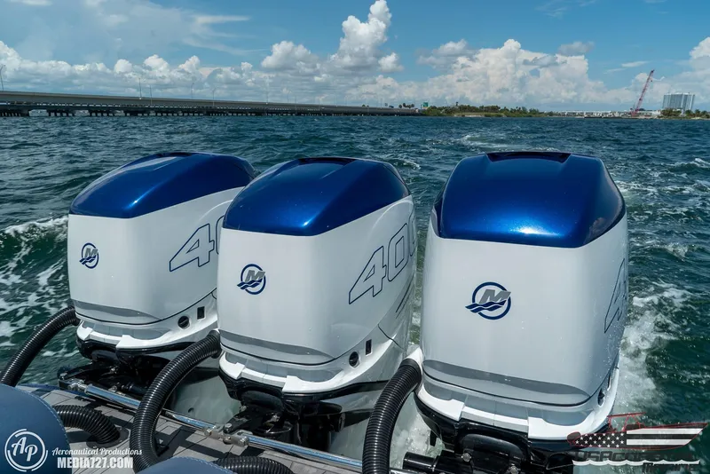 Slide: The Image of Triple outboard engines on a 2018 Statement 38 Open boat cruising on open water. - 36