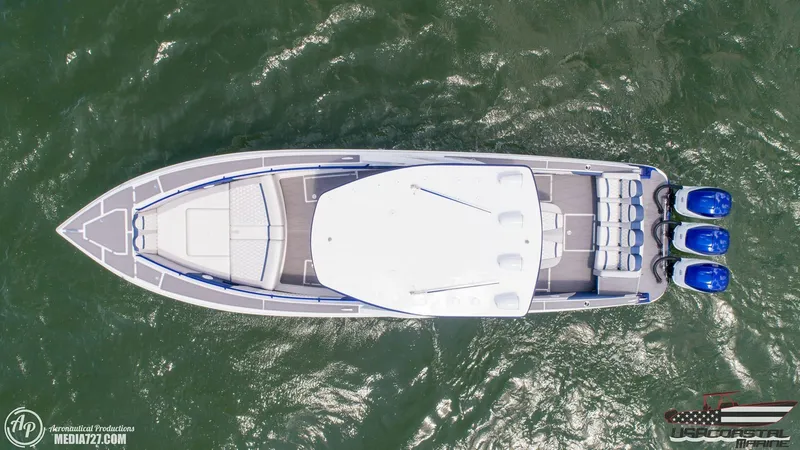 Slide: The Image of Aerial view of 2018 Statement 38 Open boat with triple engines on water. - 37