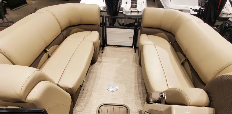 Slide: The Image of 2023 Regency 230 DL3 pontoon boat with beige seating and spacious interior. - 2