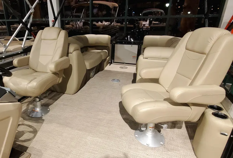 Slide: The Image of 2023 Regency 230 DL3 boat interior with beige leather seats and spacious layout. - 4