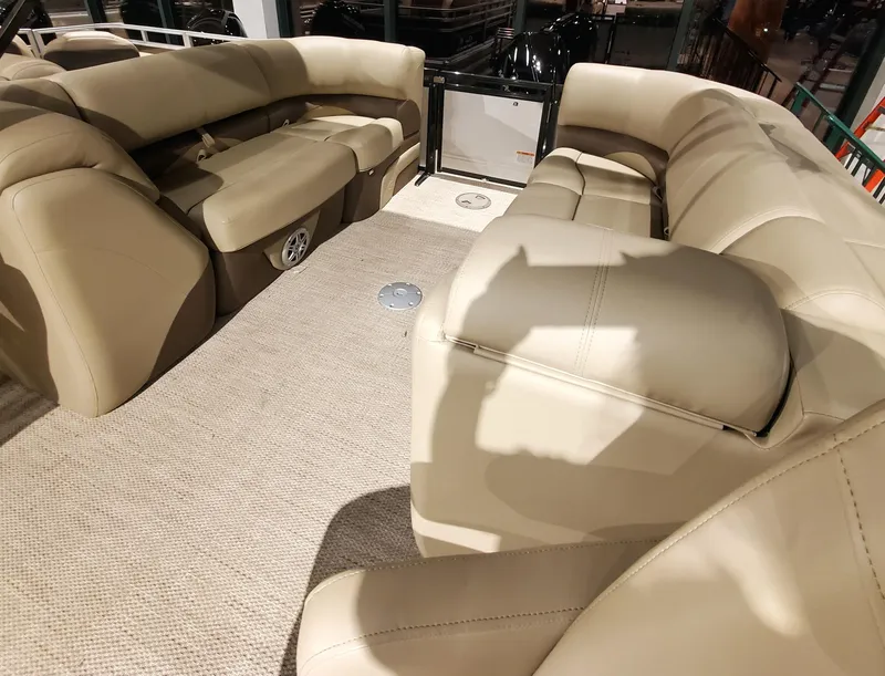 Slide: The Image of 2023 Regency 230 DL3 pontoon boat with beige leather seating. - 5