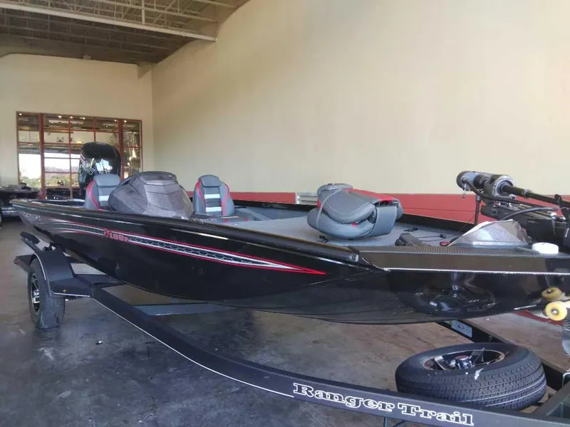 Slide: The Image of 2023 Ranger RT188P fishing boat in showroom, black with red accents. - 0