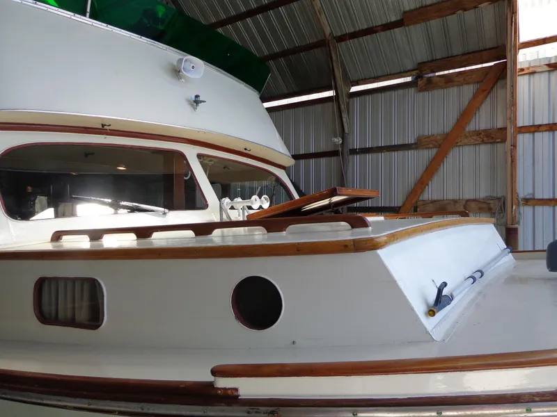 Slide: The Image of 1946 Monk Flybridge Sedan boat in a covered dock. - 15