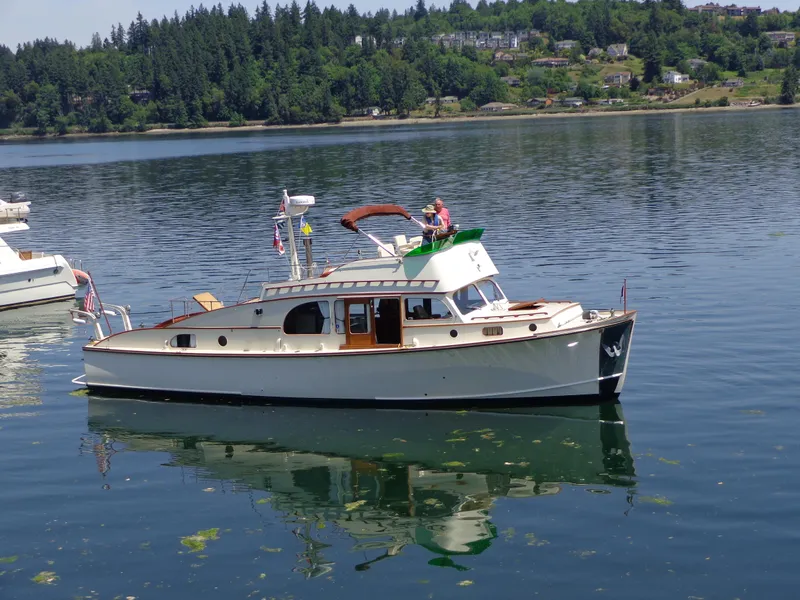 Slide: The Image of 1946 Monk Flybridge Sedan boat in a warehouse, PTSC on the hard 2017. - 2