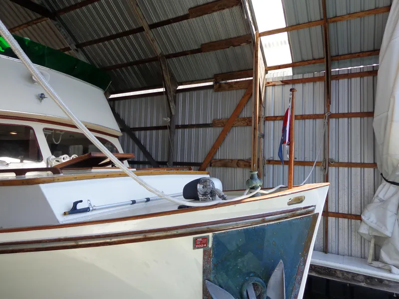 Slide: The Image of 1946 Monk Flybridge Sedan boat docked in a covered marina. - 20