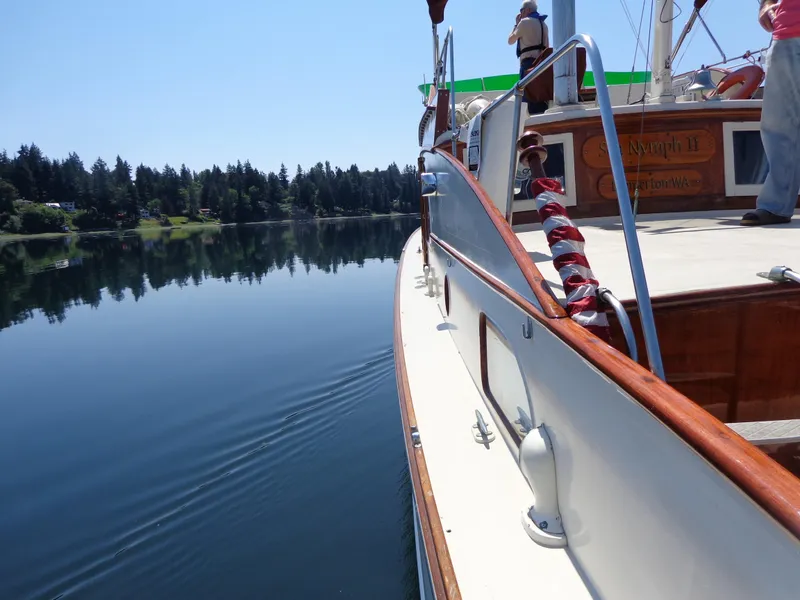 Slide: The Image of 1946 Monk Flybridge Sedan cruising on a calm lake. - 29