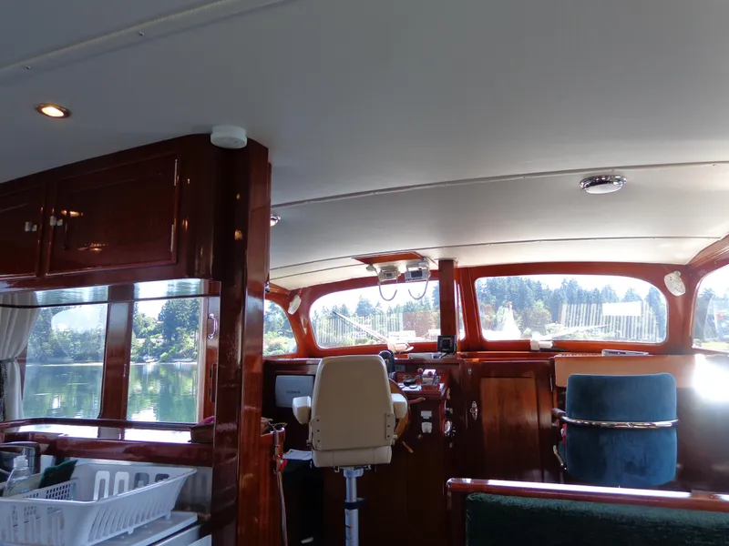 Slide: The Image of Interior of a 1946 Monk Flybridge Sedan boat with wooden finishes and large windows. - 34