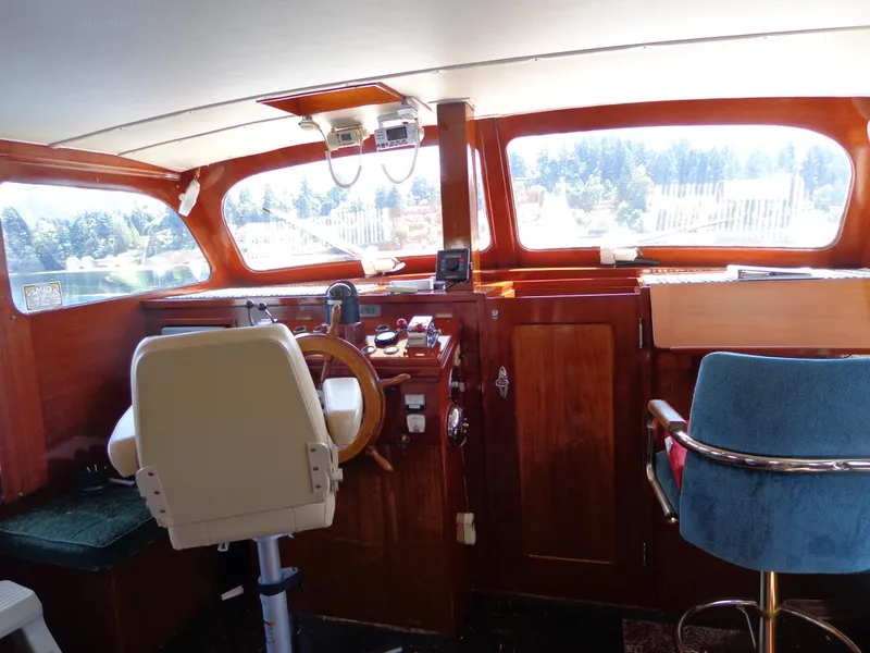 Slide: The Image of 1946 Monk Flybridge Sedan boat interior with wooden helm and seating. - 38