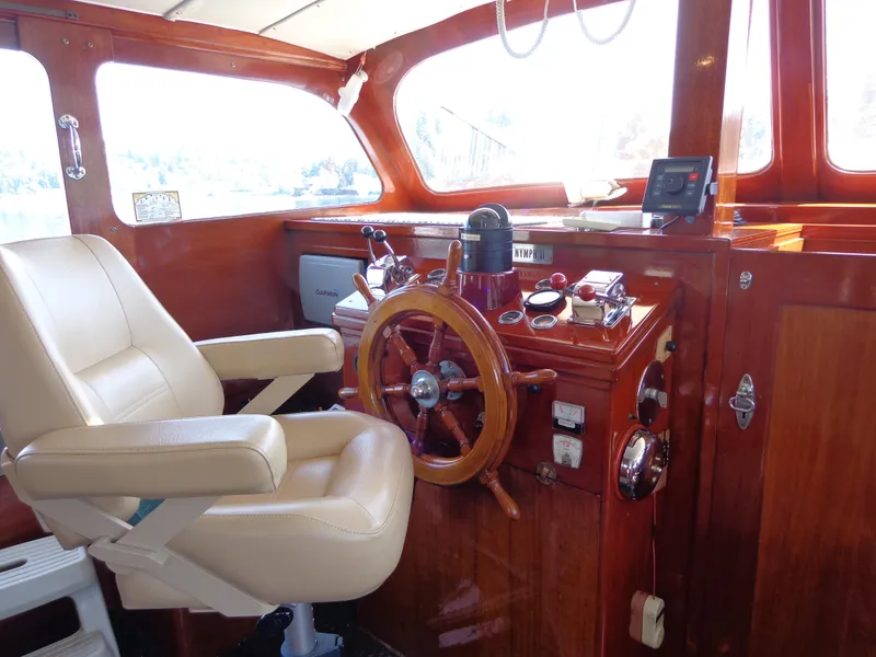 Slide: The Image of 1946 Monk Flybridge Sedan boat interior with wooden helm and captain's chair. - 39