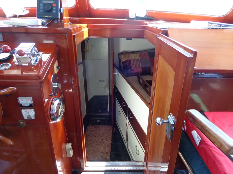 Slide: The Image of 1946 Monk Flybridge Sedan interior with wooden cabinetry and cozy sleeping quarters. - 42