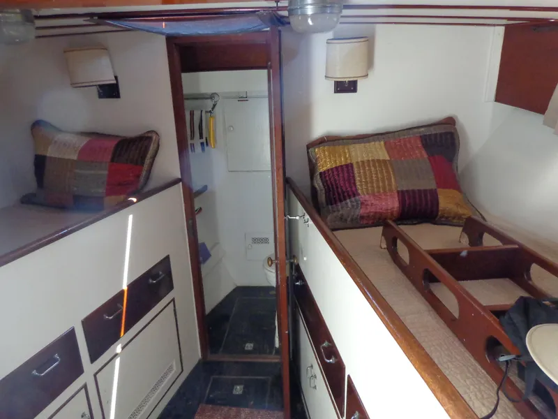 Slide: The Image of 1946 Monk Flybridge Sedan interior with twin beds and colorful pillows. - 43