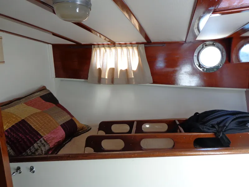 Slide: The Image of 1946 Monk Flybridge Sedan cabin with wooden interior and porthole window. - 47