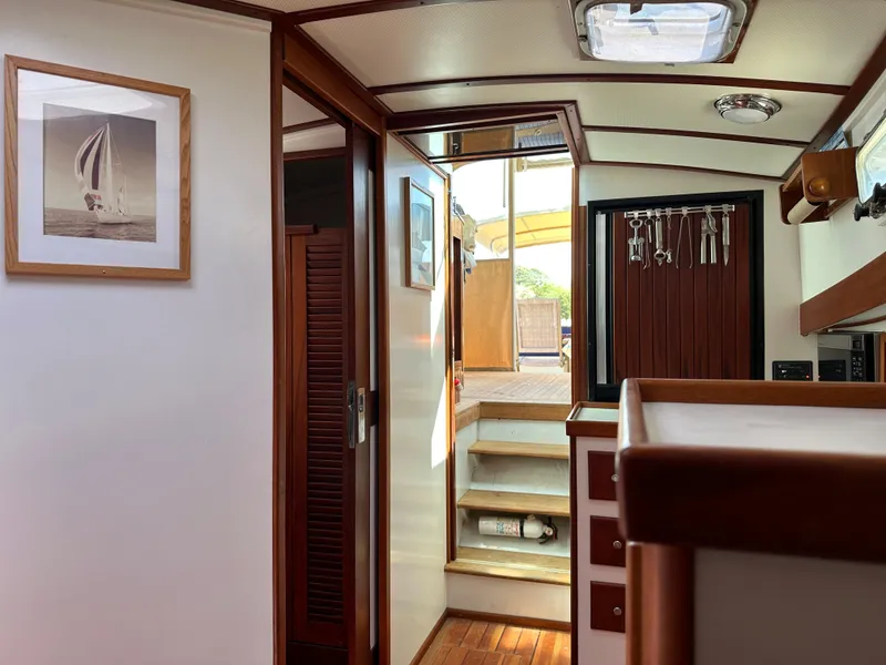 Slide: The Image of Interior of 2001 Mast & Mallet 38 Picnic Boat with wooden accents and framed artwork. - 12