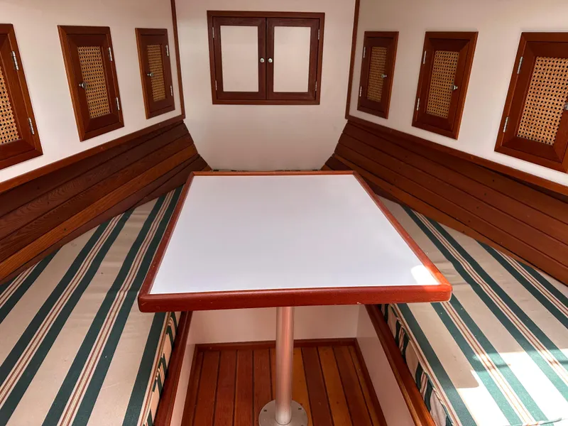 Slide: The Image of Interior of 2001 Mast & Mallet 38 Picnic Boat with wooden accents and striped seating. - 15