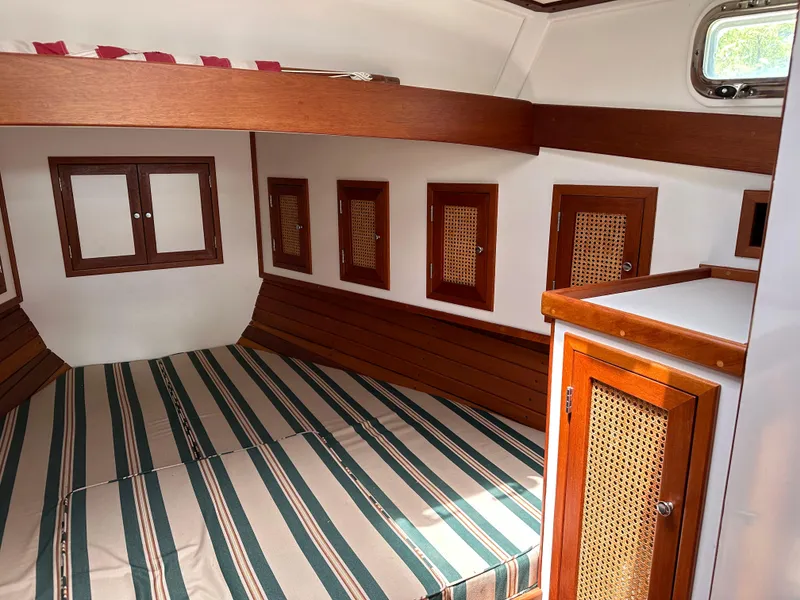 Slide: The Image of Cozy cabin interior of 2001 Mast & Mallet 38 Picnic Boat with striped bedding. - 17