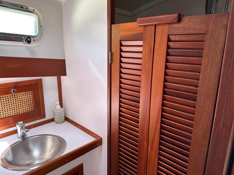 Slide: The Image of 2001 Mast & Mallet 38 Picnic Boat interior with wooden cabinetry and stainless steel sink. - 20