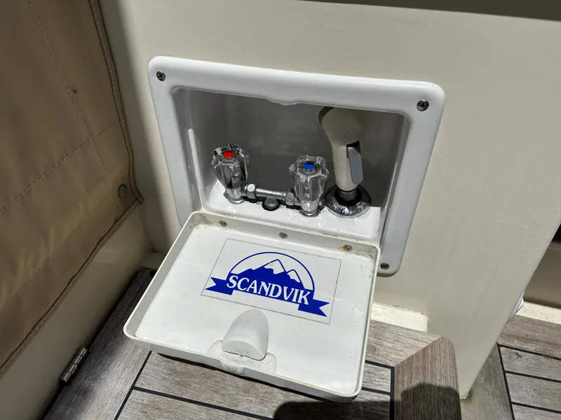 Slide: The Image of Outdoor shower controls on a 2001 Mast & Mallet 38 Picnic Boat, featuring Scandvik fixtures. - 29